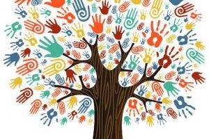 Tree with the leaves replaced by differently shaped, sized, and colored human hand prints.
